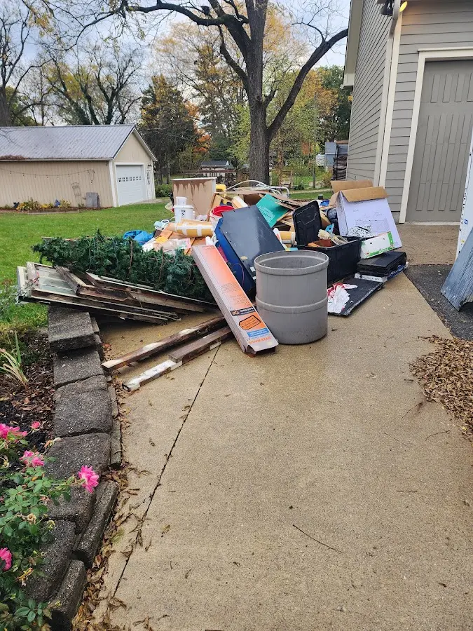 Dumpster being loaded with debris for Roofing Dumpster Rental in Bennett